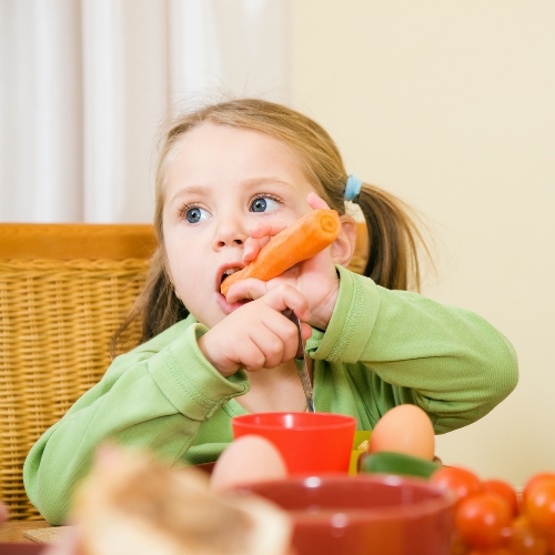 kid eating carrot
